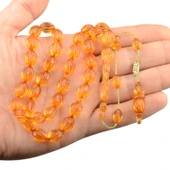 Sistem Püsküllü 11x8mm Oyma İşçilikli İmzalı Ateş Kehribar Tesbih thumbnail 1