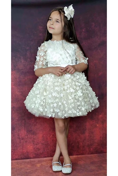 Kız Çocuk Kolları Şeffaf Tüllü ve Üzeri Papatya Motifli Beli Şerit Detaylı Krem Elbise ürün görseli