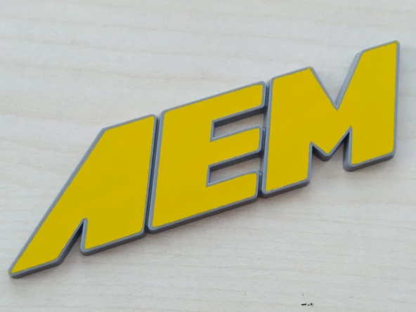 AEM YAZISI 10x2,5cm KABARTMA SPORT ARMA SARI-GRİ (AEM ARMASI) AEM LOGOSU ürün görseli 1