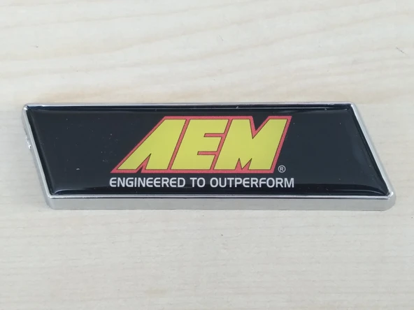 AEM ARMASI 10x3cm KÖŞELİ SPORT ARMA (AEM LOGOSU) AEM YAZISI - ÇAMURLUK ve BAGAJ ARMASI ürün görseli 1